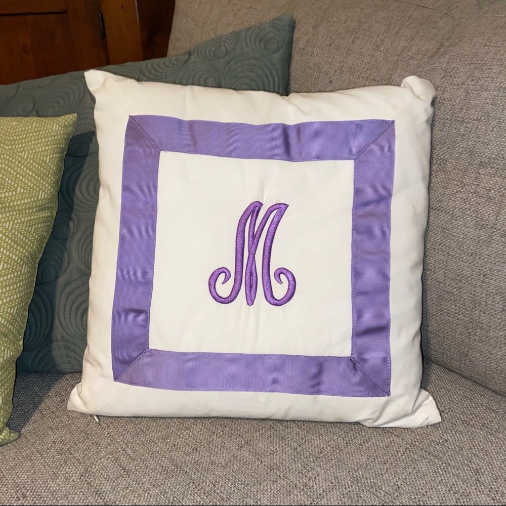 Embroidered purple “M” throw pillow